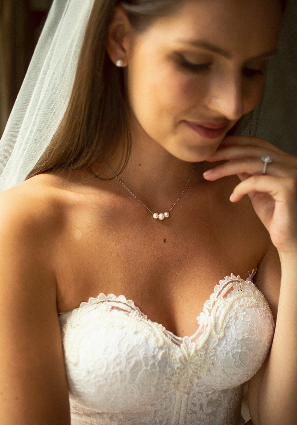 bride wearing abacus pearl necklace and button studs