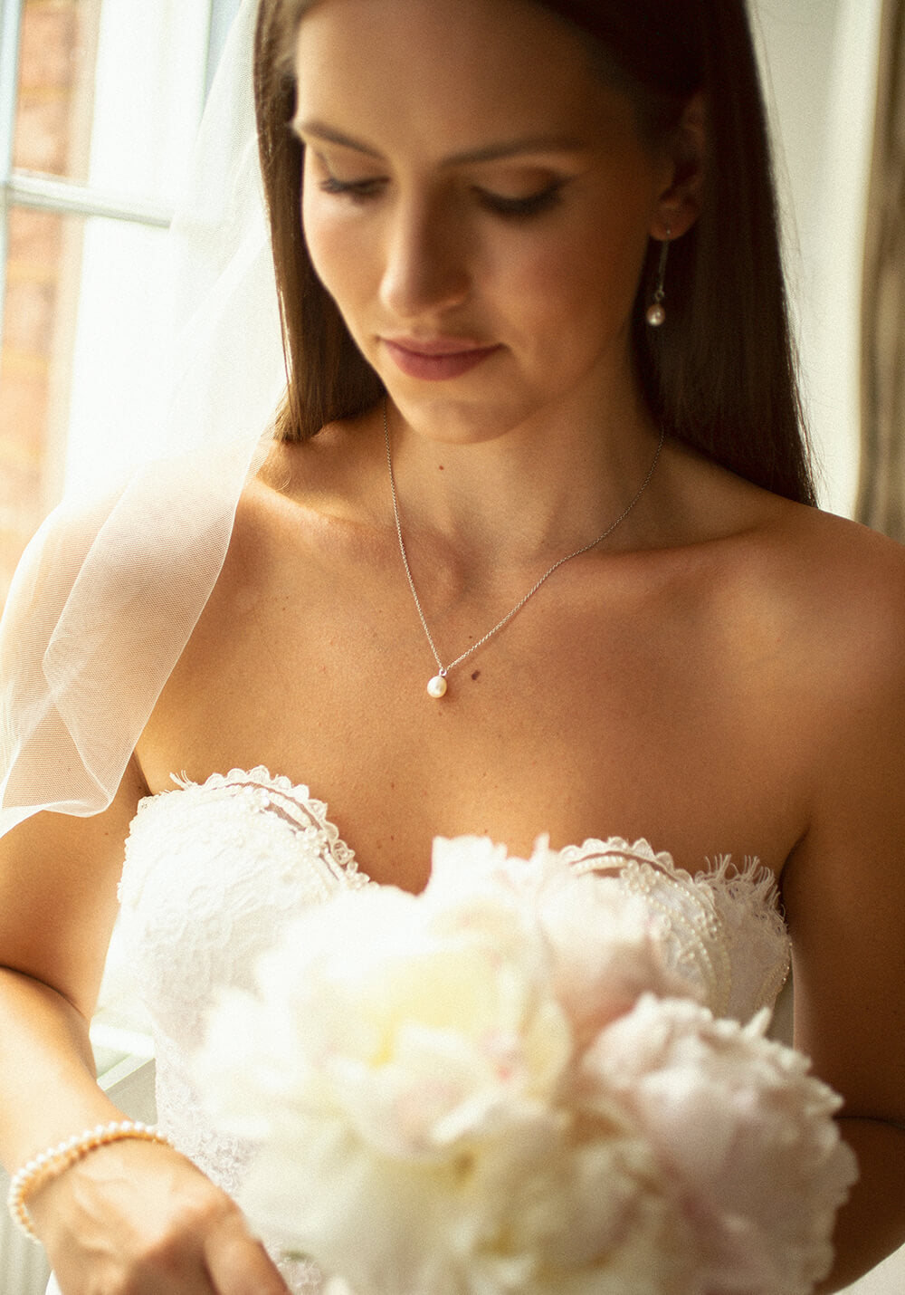 bride wearing favourite pearl drop necklace