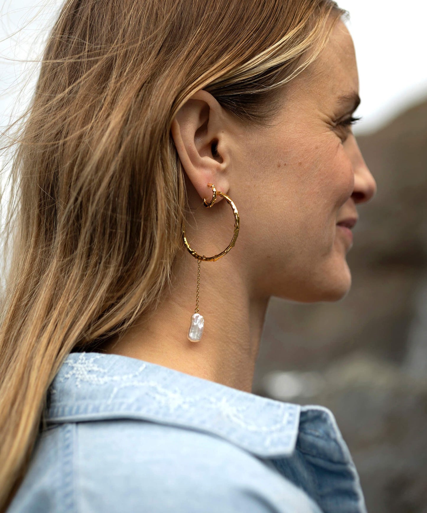 Large volcano hoop gold earrings with long biwa pearl drop