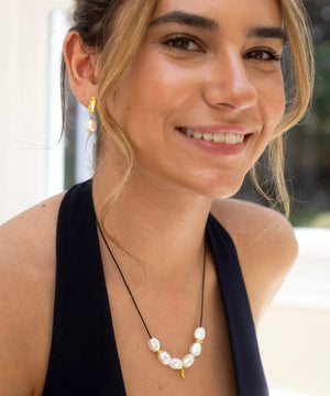 Large Baroque pearl and gold charm necklace, on adjustable cord