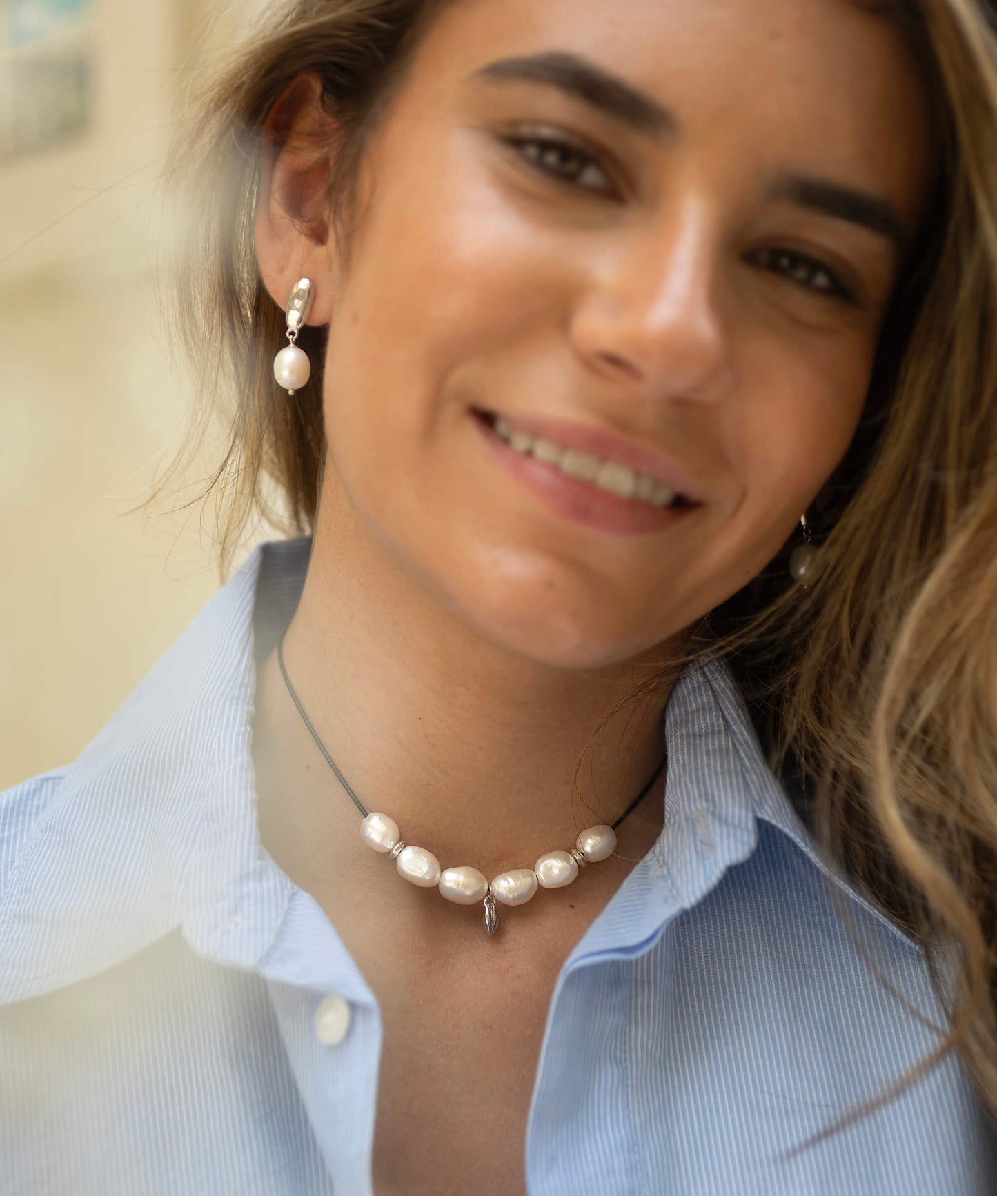 Large Baroque pearl and silver charm necklace, on adjustable cord